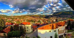 an aerial view of a city with buildings and mountains at SARAJEVO-ADI APARTMENTS II in Sarajevo