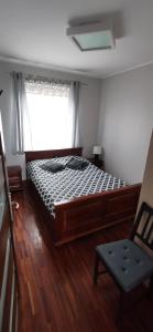 a bedroom with a bed and a window and a chair at Apartament Familijny Gdańsk 3 ROOMS 64m2 in Gdańsk