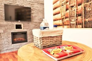 uma mesa com um cesto de comida e uma lareira em Appart'Confort - Le Lodge em Saint-Brieuc