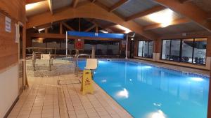 a large swimming pool in a building at Keer lodge - Pine Lake Resort in Carnforth