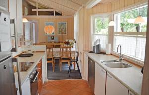 a kitchen with a counter and a dining room at Amazing Home In Vejby With 3 Bedrooms And Wifi in Vejby