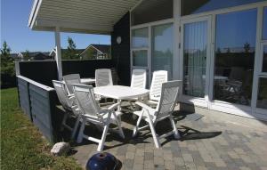 a white table and chairs on a patio at Holiday Home Strandparken in Otterup
