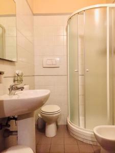 a bathroom with a shower and a toilet and a sink at B&B Locanda La Rotonda in Montale