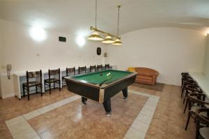 a room with a pool table and chairs at Anette Hotel in Prague