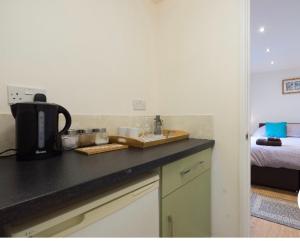 a kitchen with a counter with a coffee maker on it at Alexandra Annexe in Bath