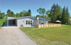 una pequeña casa blanca con un gran patio en Beautiful Home In Ebeltoft With Kitchen en Øksenmølle