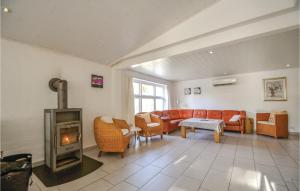 a living room with a couch and a fireplace at Four-Bedroom Holiday Home Ebeltoft With A Fireplace 04 in Øksenmølle +24 photos