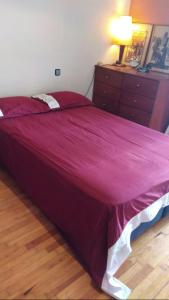 a bedroom with a large bed with a purple bedspread at Private Room In a Shared Flat in Thessaloniki