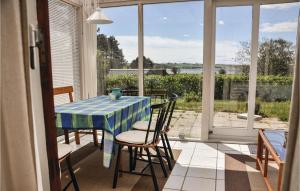 a table and chairs on a porch with a view of the water at Lovely Home In Millinge With Kitchen in Millinge