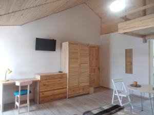 a room with a desk and a table and chairs at Апартаменти Декорум in Skhidnitsa