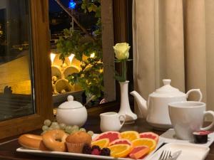 a table with a plate of food on a table at Studio Boutique Hotel at Cascade in Yerevan