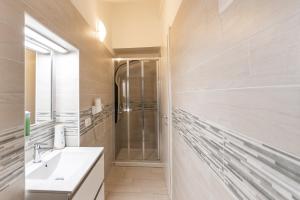 a bathroom with a shower, sink, and mirror at Residence Finale Bike and Beach in Finale Ligure