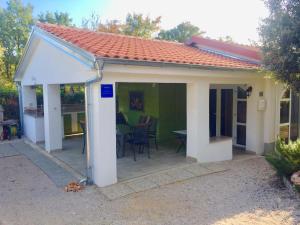 a pavilion with a table and chairs on a patio at SEASIDE VACATION RENTAL 4TUNA in Krk