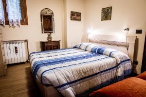 a bedroom with two beds and a mirror at Appartamento Valeria in Terminillo