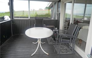 una mesa blanca y 2 sillas en un porche en Gorgeous Home In Aabenraa With House Sea View, en Aabenraa