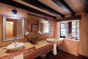 une salle de bain avec deux lavabos et deux miroirs dans l'établissement Hotel Finca Ca N'ai - Adults Only, à Sóller