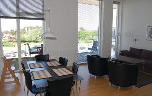 a living room with two tables and chairs and a couch at Pet Friendly Apartment In Rm With Wifi in Rømø Kirkeby