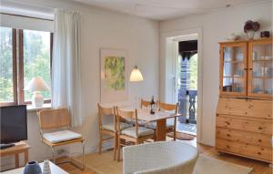 a living room with a table and a dining room at 1 Bedroom Cozy Apartment In Hornbk in Hornbæk
