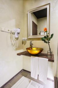 a bathroom with a wooden sink and a mirror at Hotel Ostrov in Nymburk