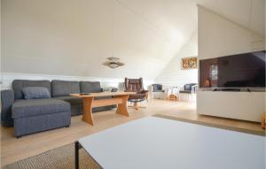 a living room with a couch and a table at Two-Bedroom Holiday Home In Ebeltoft in Ebeltoft