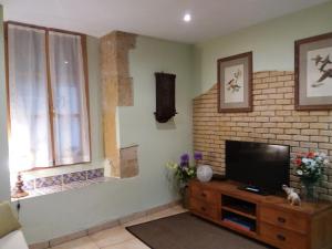 a living room with a flat screen tv and a window at Ventallols in Tarragona