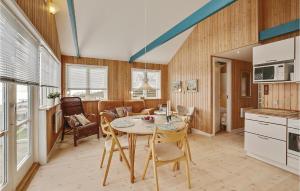 a kitchen and dining room with a table and chairs at Holiday Home Ny Bamsestræde O-624 in Otterup +8 photos