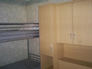 a bedroom with two bunk beds and a wooden cabinet at Charlierhelling app 22 in Blankenberge