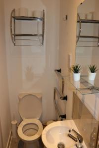 a bathroom with a toilet and a sink at Modern Newgate Apartments - Convenient Location, Close to All Local Amenities in Stoke on Trent