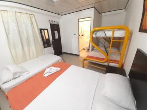 Postel nebo postele na pokoji v ubytování Hotel Arcoiris Girardot