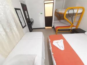 Postel nebo postele na pokoji v ubytování Hotel Arcoiris Girardot