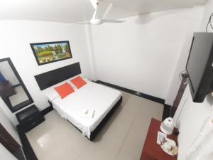 Postel nebo postele na pokoji v ubytování Hotel Arcoiris Girardot