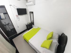 Postel nebo postele na pokoji v ubytování Hotel Arcoiris Girardot