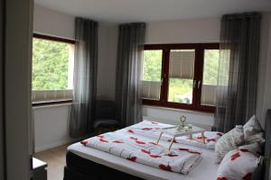 a bedroom with a bed and two windows at Adlerhorst in Zislow