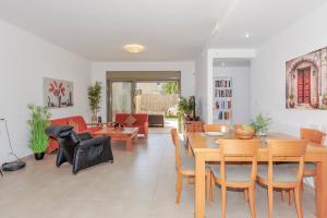 a living room with a table and chairs at Family-Friendly Apartment in Zichron Yaakov in Zikhron Ya'akov