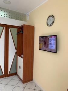 a room with a clock on the wall and a door at Playa Apartment 230 - 230 bis in Catania