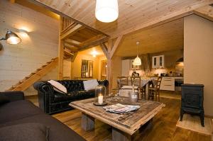 a living room with a couch and a table at Chalet Le Villarais in Villard-Reculas