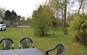 a table and two chairs in a yard with a park at Nice Home In Vggerlse With Wifi in Bøtø By
