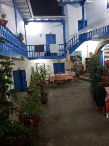 a room with tables and potted plants and a staircase at Hospedaje Euro's De San Blas in Cusco