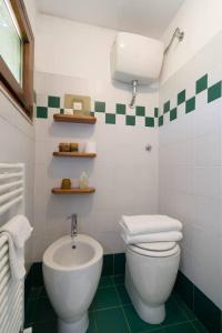 a bathroom with a white toilet and a sink at Pin de stèlle in San Martino