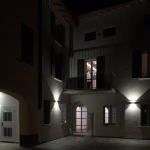 an empty building with lights in the dark at Residenza Giulio Romano in Mantova
