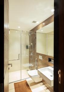 a bathroom with a shower and a toilet and a sink at Hotel Divine Fort in Palni