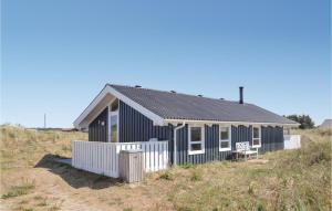 a blue house on top of a hill at Stunning Home In Hirtshals With 2 Bedrooms, Sauna And Wifi in Hirtshals