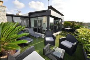 a rooftop patio with chairs and a table at Hôtel de Provence in Cannes
