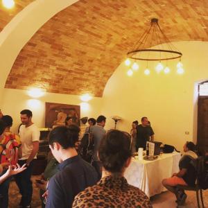a group of people standing around a room with a table at Dimora dell'Arte-CantinArte in Navelli +113 photos