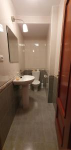 a bathroom with a sink and a toilet at Duplex Calle Padre Lerchundi con Parking y wifi in Chipiona +21 photos