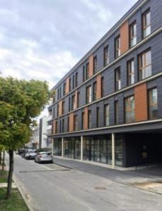 budynek na ulicy z samochodami zaparkowanymi przed nim w obiekcie Apartament na Złotej w Kielcach
