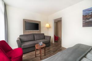 a living room with a couch and a chair at Hotel Oxelösund in Oxelösund