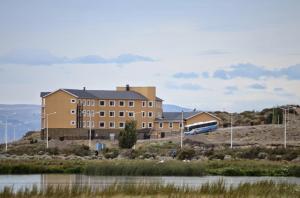 a building with a train in front of it at Hotel Las Dunas in El Calafate