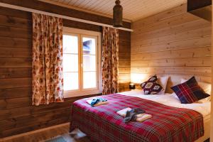 a bedroom with a bed in a log cabin at Arctic Sky Lapland in Saariselka