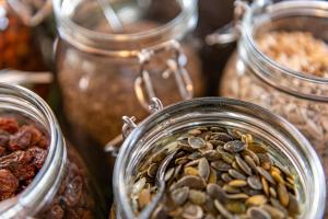 a group of glass jars filled with nuts and seeds at Hotel Oxelösund in Oxelösund